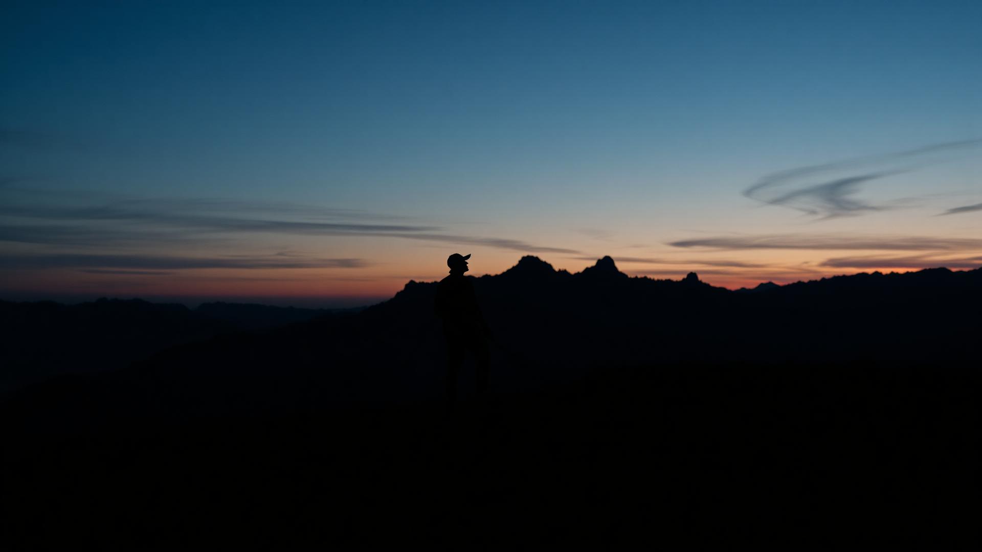 Golfer silhouette at dusk in the Alps